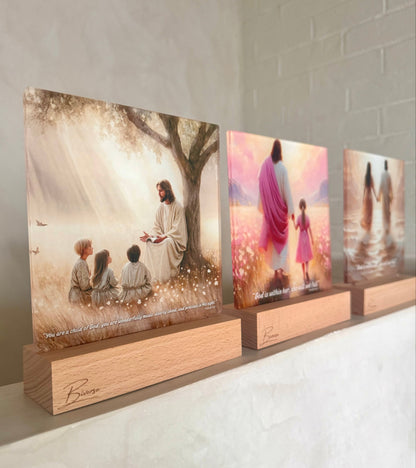 Three BIVERSE acrylic decor lamps with illustrated religious designs displayed on a ledge.