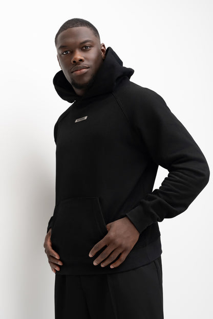Model wearing the Noir black BIVERSE hoodie, three-quarter front view.