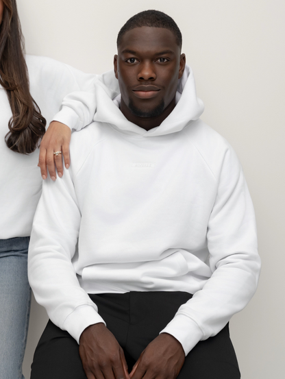 Seated model wearing the Snow white BIVERSE hoodie, front view.