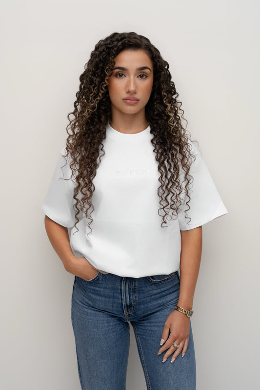 Model wearing the Snow white BIVERSE tee with jeans, front view.