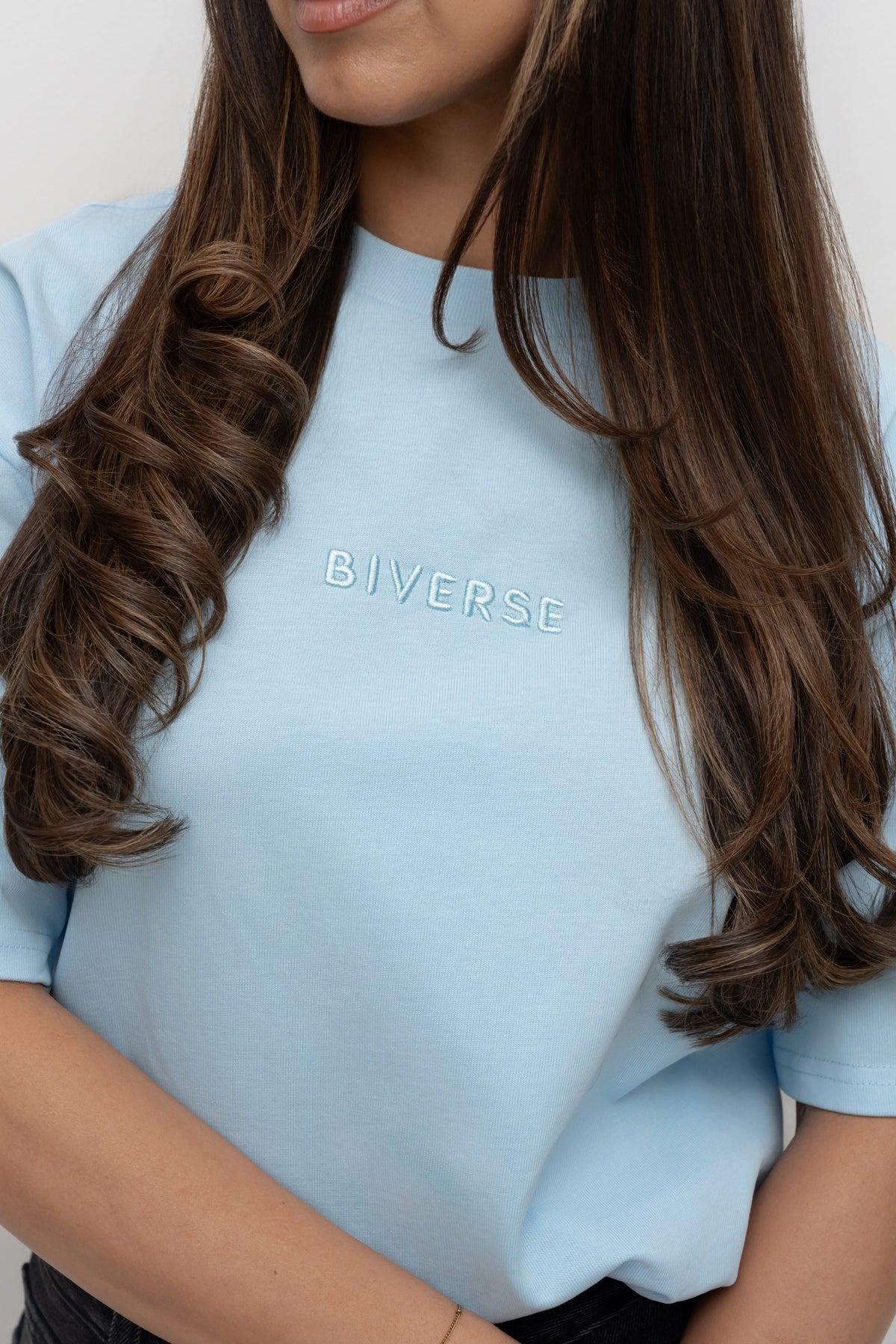 Close-up of the embroidered chest logo on the Sky blue BIVERSE tee.