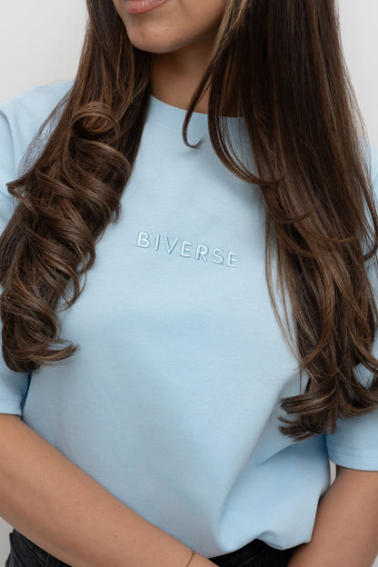 Close-up of the embroidered chest logo on the Sky blue BIVERSE tee.