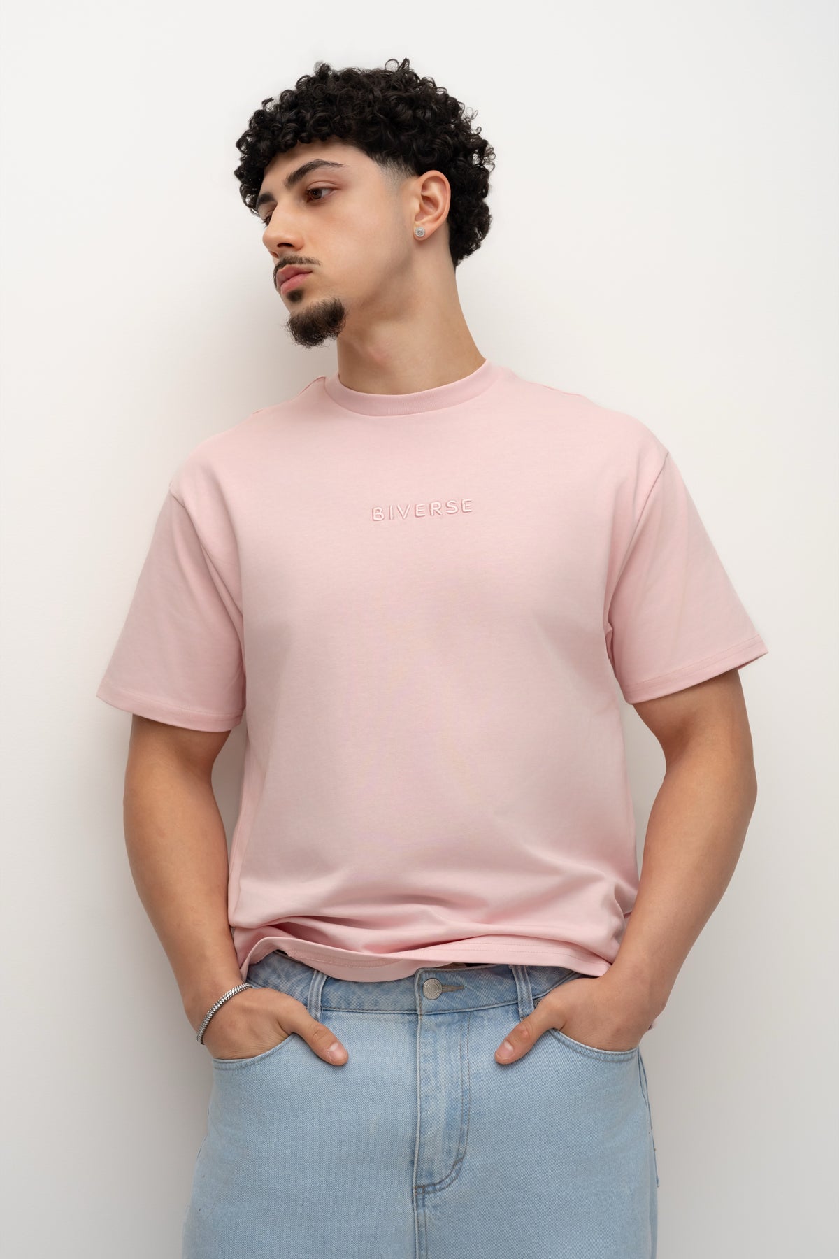 Model wearing the Blush pink BIVERSE tee with jeans, front view.