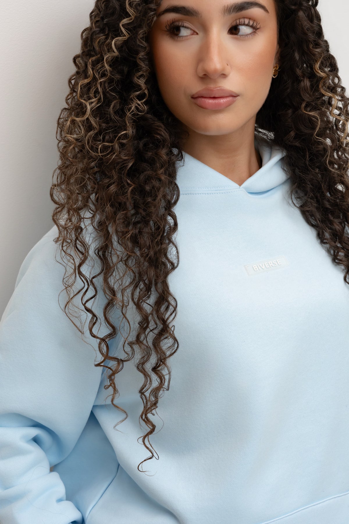 Close-up of the Sky blue BIVERSE hoodie neckline and chest logo.