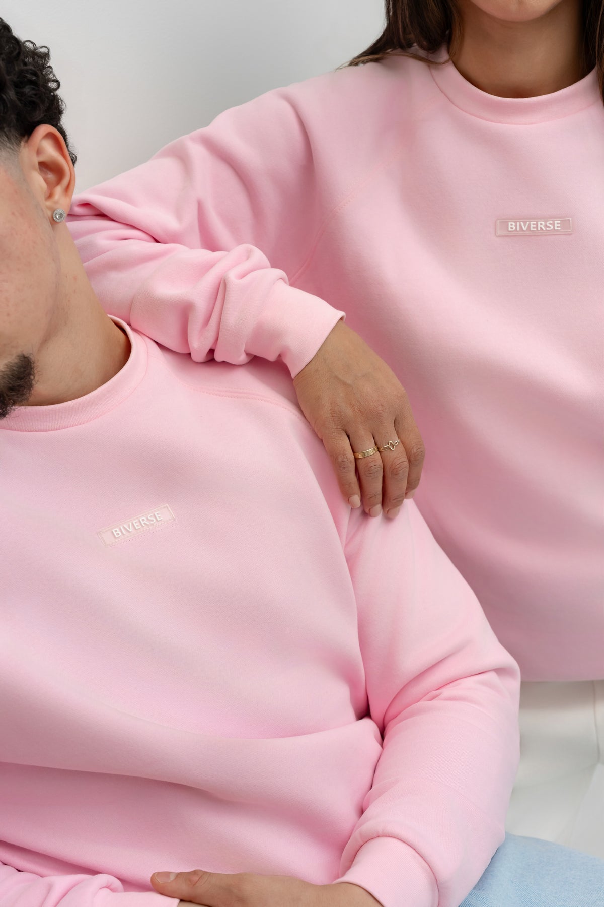 Close-up of Candy pink BIVERSE hoodie and crewneck chest details.
