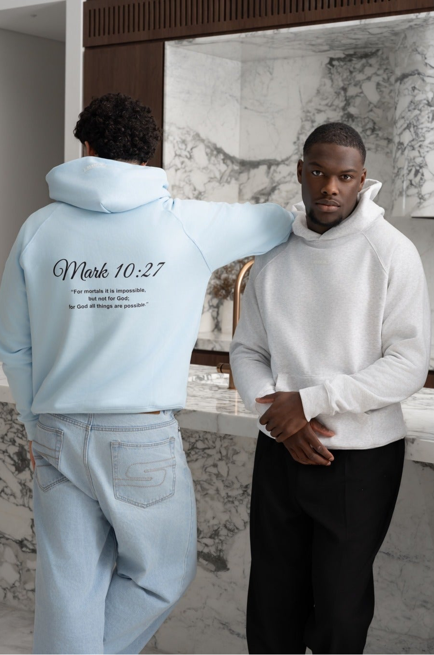 Sky blue BIVERSE hoodie with Mark 10:27 printed on the back beside a model wearing a light grey hoodie.